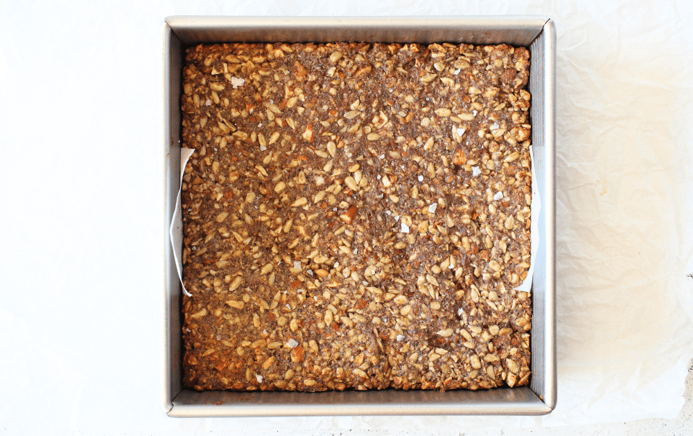 homemade keto granola bar in an 8 x 8 pan after being baked