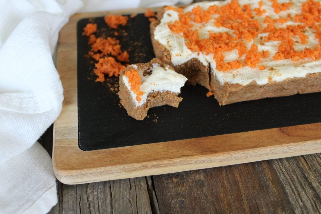 These bars only take minutes to prepare. The hardest part waiting for them to solidify in the fridge. Combining almond flour, coconut flour, pureed carrots and butter, these dense little treats will become a regular addition to your families desserts. #Low Carb #keto #carrot Cake #bars #gluten Free #easy.