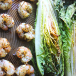 This sheet pan grilled romaine lettuce, shrimp and bacon come together in minutes for the perfect Whole30 Caesar salad. Easy and simple Whole30 Caesar dressing is made while the romaine is baking.