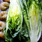 This sheet pan grilled romaine lettuce, shrimp and bacon come together in minutes for the perfect Whole30 Caesar salad. Easy and simple Whole30 Caesar dressing is made while the romaine is baking.
