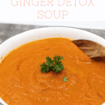 Carrot soup in a pot with a spoon