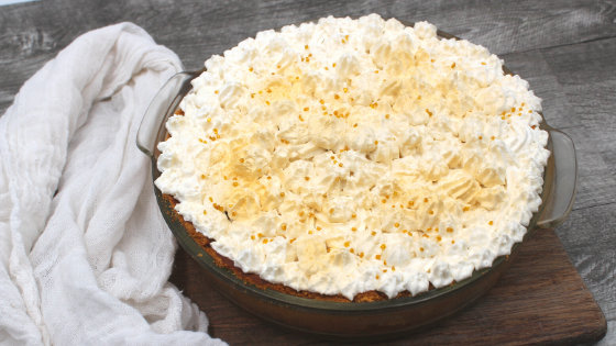 Baked coconut cream pie on a cutting board