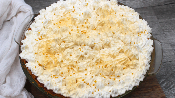Baked coconut cream pie with whipped cream frosting