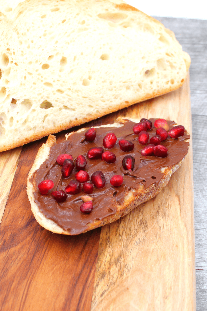 pomegranate seeds on chocolate spread