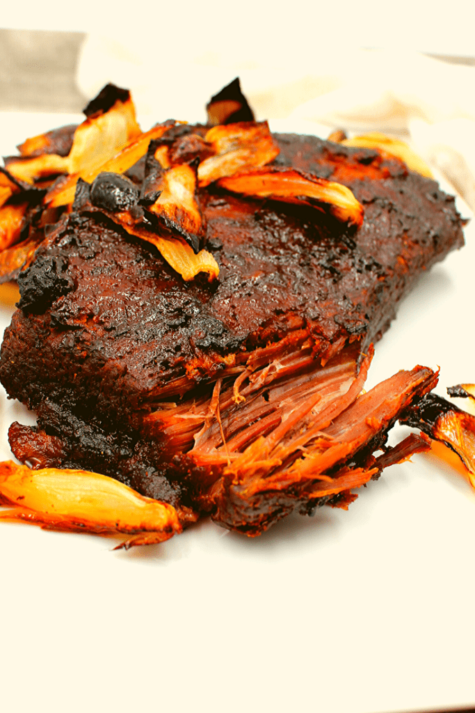 Charred onions on top of a maple soy brisket