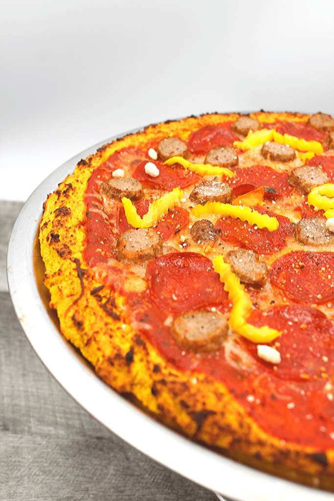 Pepperoni and sausage adorn this gluten-free and dairy-free pizza crust.