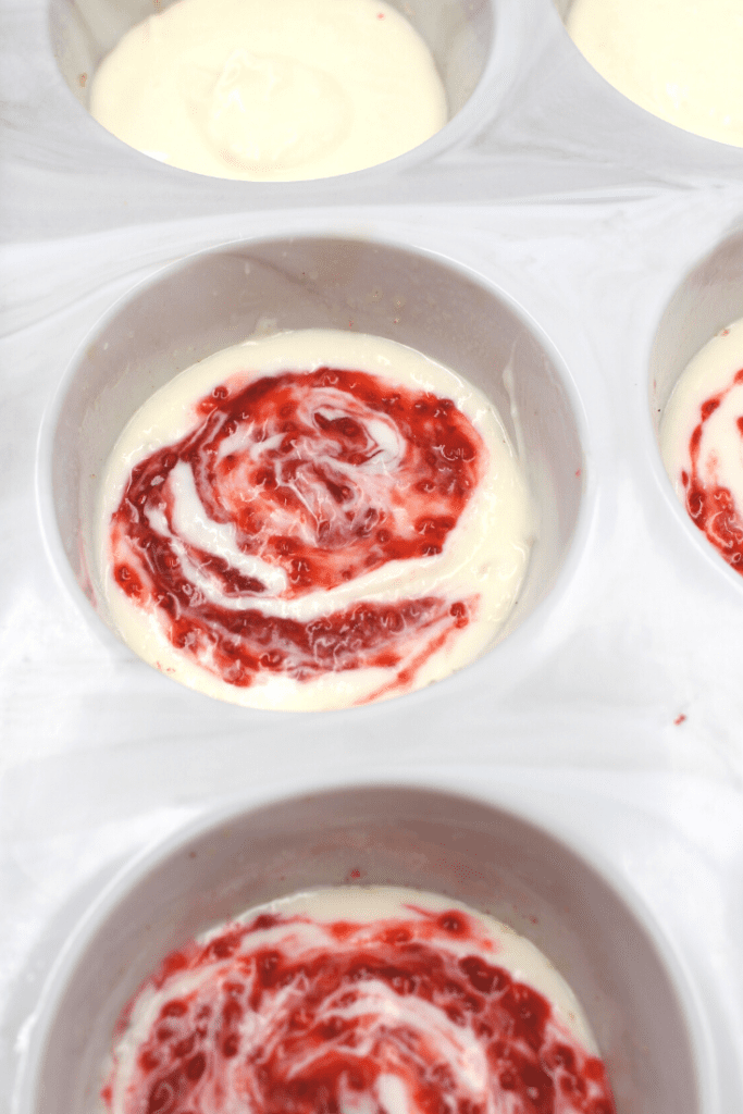 Create a strawberry swirl throughout the muffin to infuse the strawberry flavour in the white chocolate cheesecake.