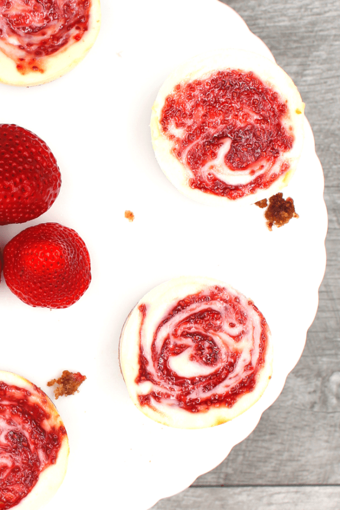 A plate of white chocolate cheesecake strawberry muffins that are gluten-free and keto.
