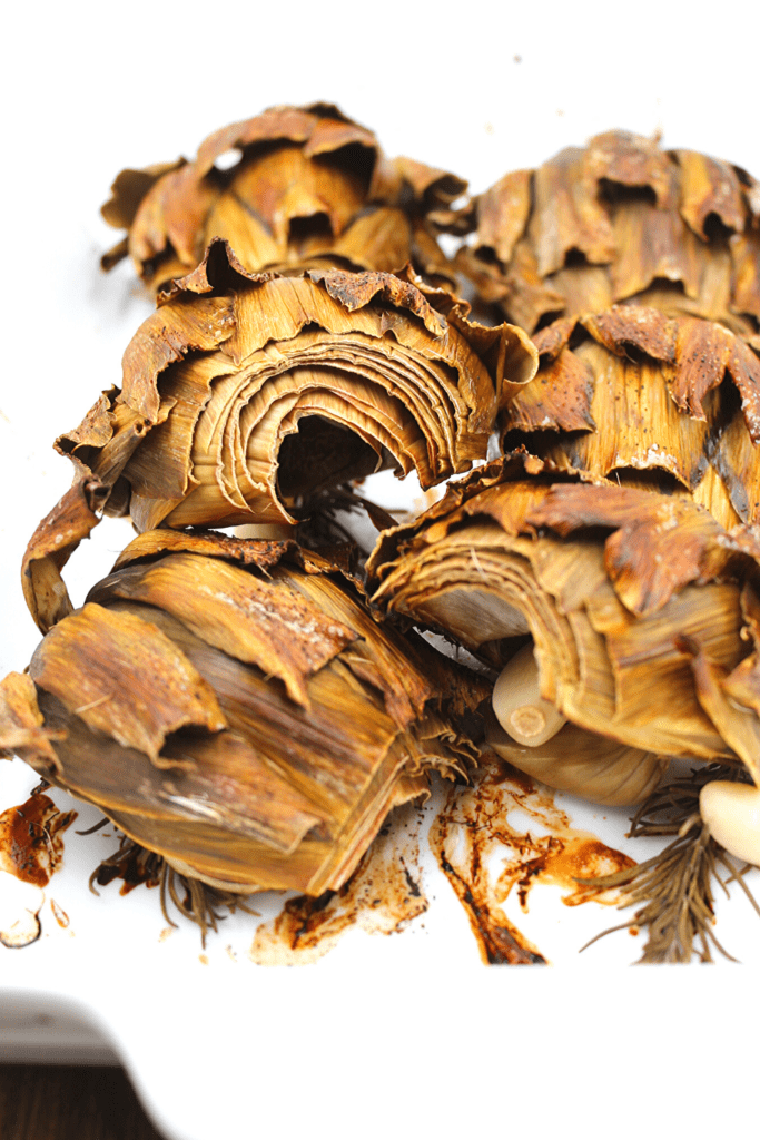 Delicious baked artichoke hearts in a baking dish.