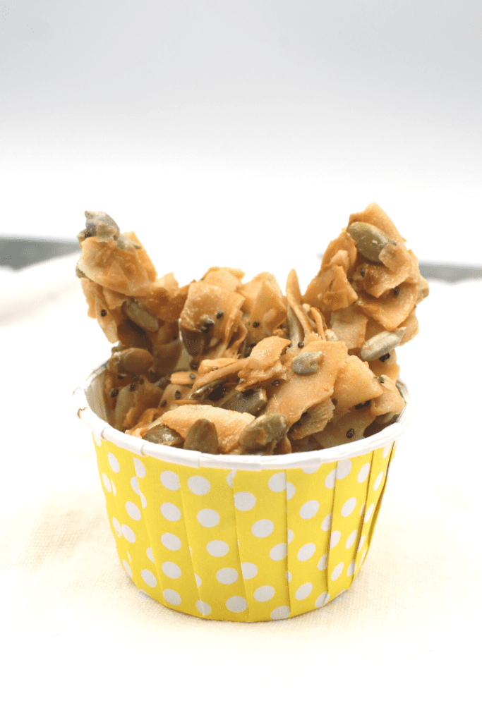 Coconut and seeds are combined to form this sweet and crunchy keto snack.