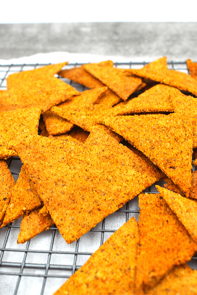 Crispy easy tortilla chips that are seasoned with a keto nacho cheese seasoning.