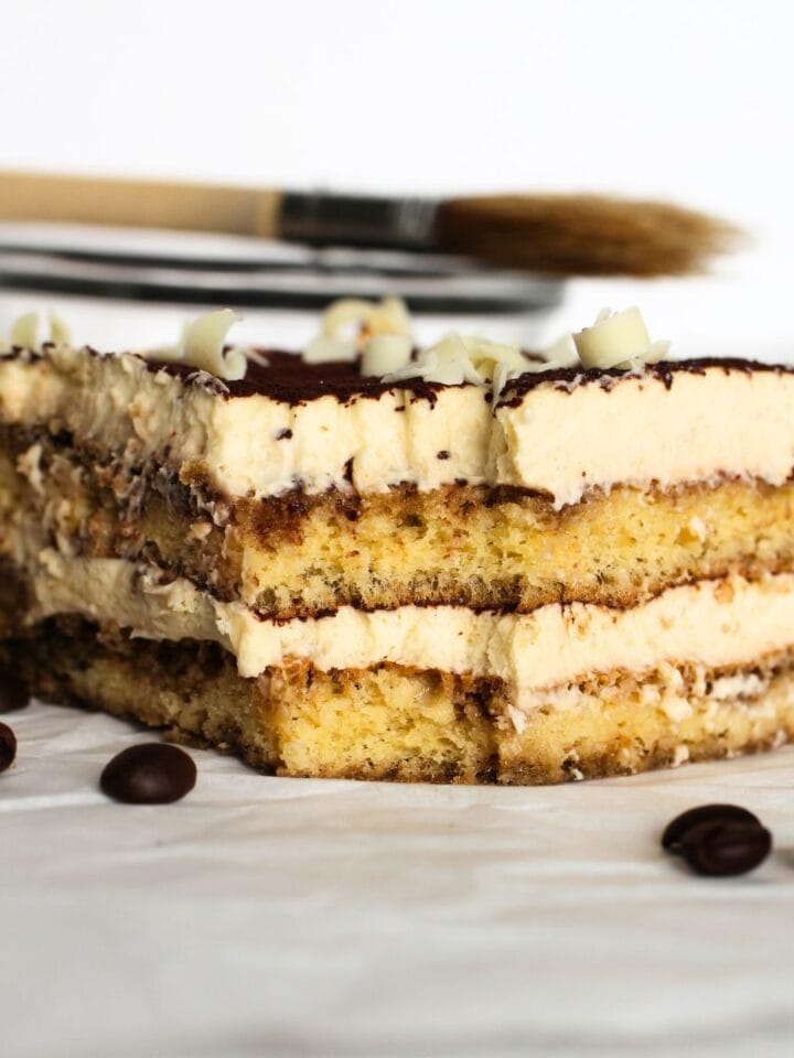 a slice of keto tiramisu with layers of gluten-free sponge soaked in coffee with mascarpone filling