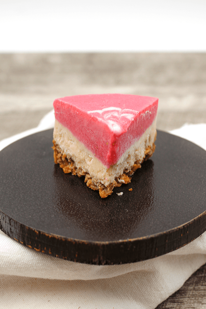 A slice of vegan and keto strawberry layered cheesecake.