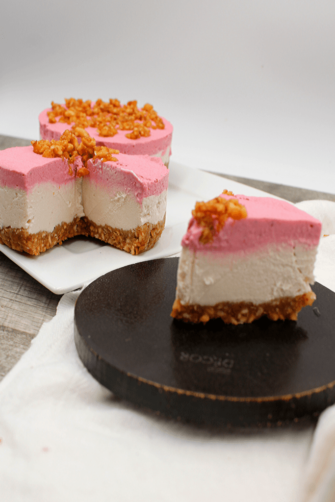 Crunchy nut bottom with creamy vegan and keto strawberry cheesecake on top is the perfect no bake dessert.