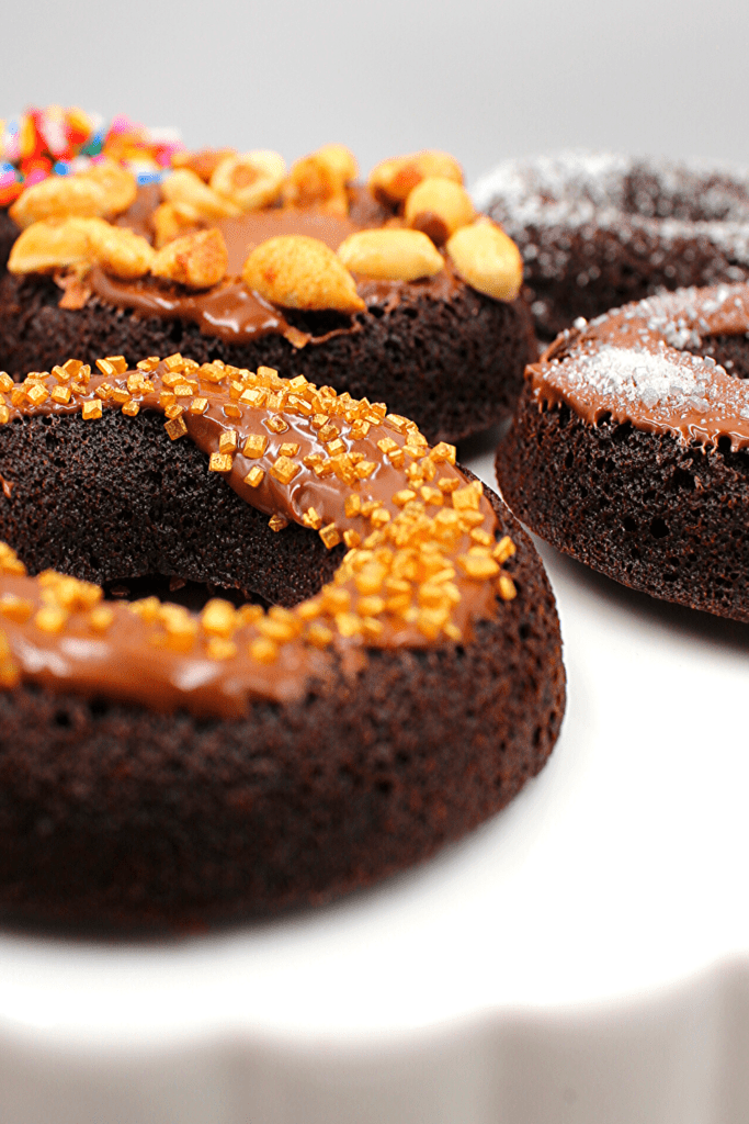 Chocolate Nutella glazed donut with gold sprinkles