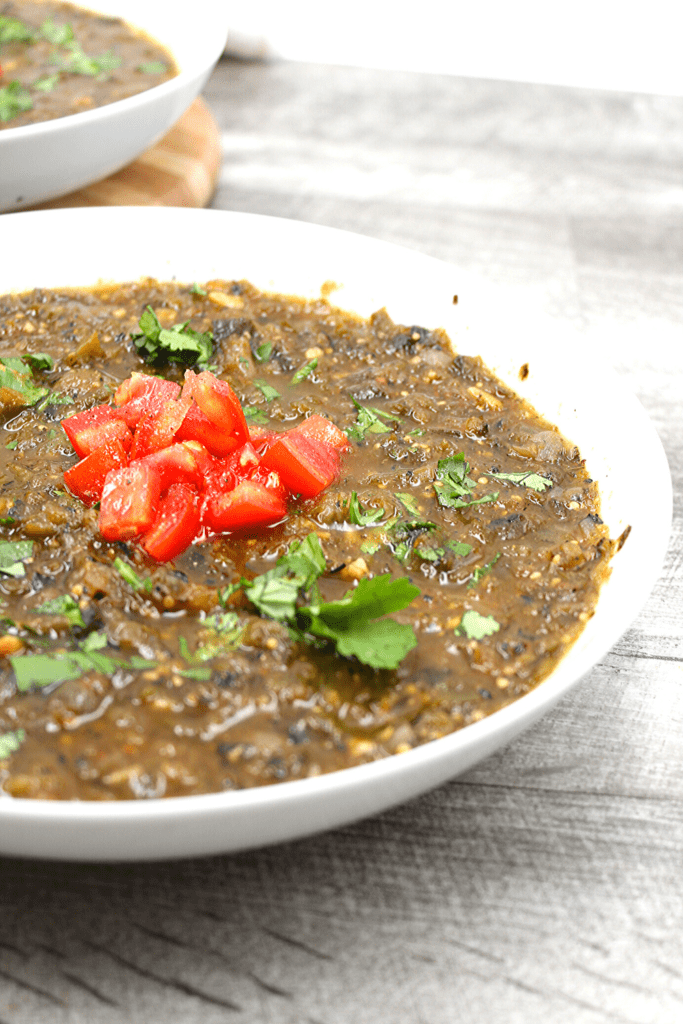 A bowl of Vegan chili verde with chopped tomatoes