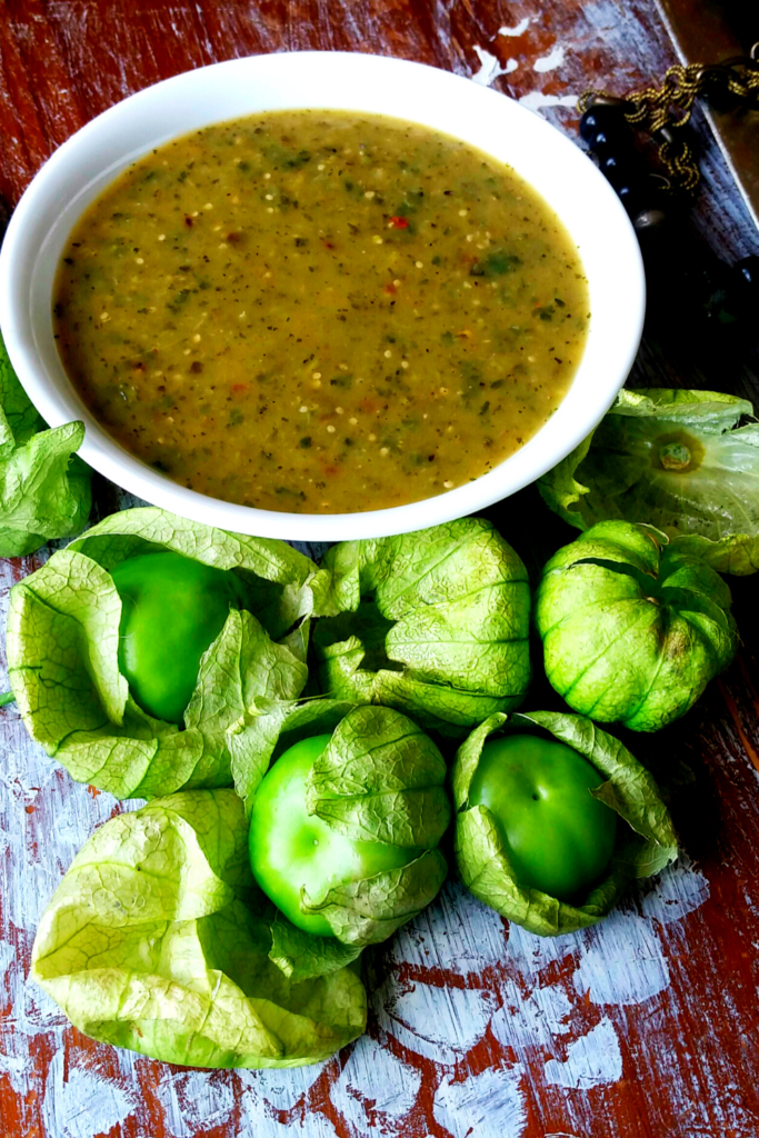Tomatillos with a bowl of salsa verde