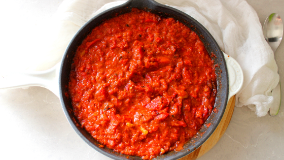 The tomato pepper sauce in a skillet before eggs are added