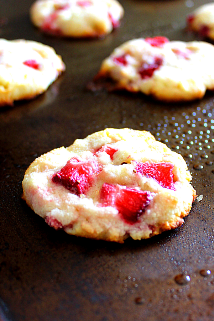 Bright chunks of delicious strawberry pieces nestled among a white chocolate cream cheese cookie