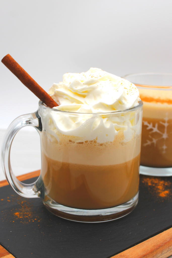 A mug filled with pumpkin spiced latte and whipped cream