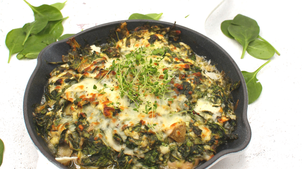 a skillet filled with chicken and artichokes