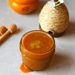 Hot honey spilling over the edge of a jar