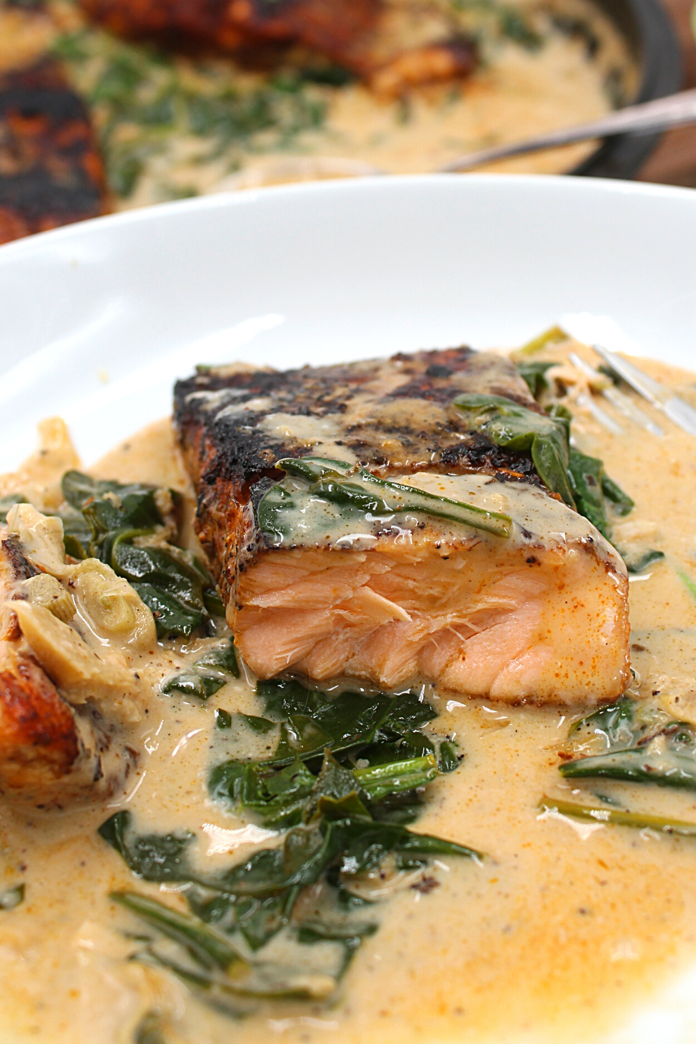 a slice of salmon in cream sauce