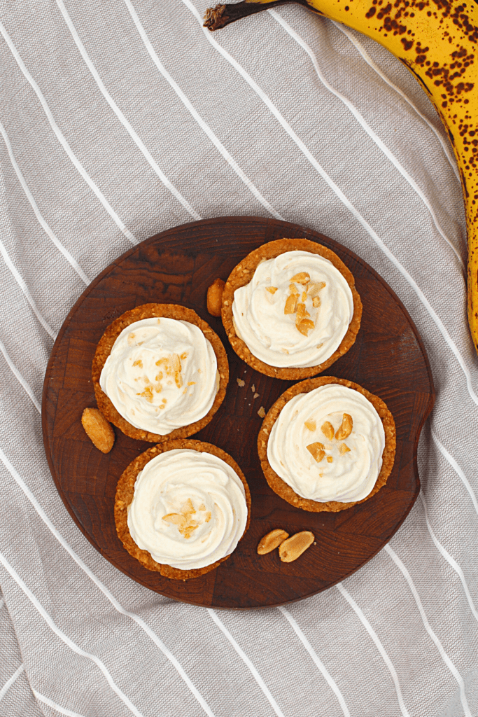 keto banana pudding in a peanut butter cookie cup with whipped cream