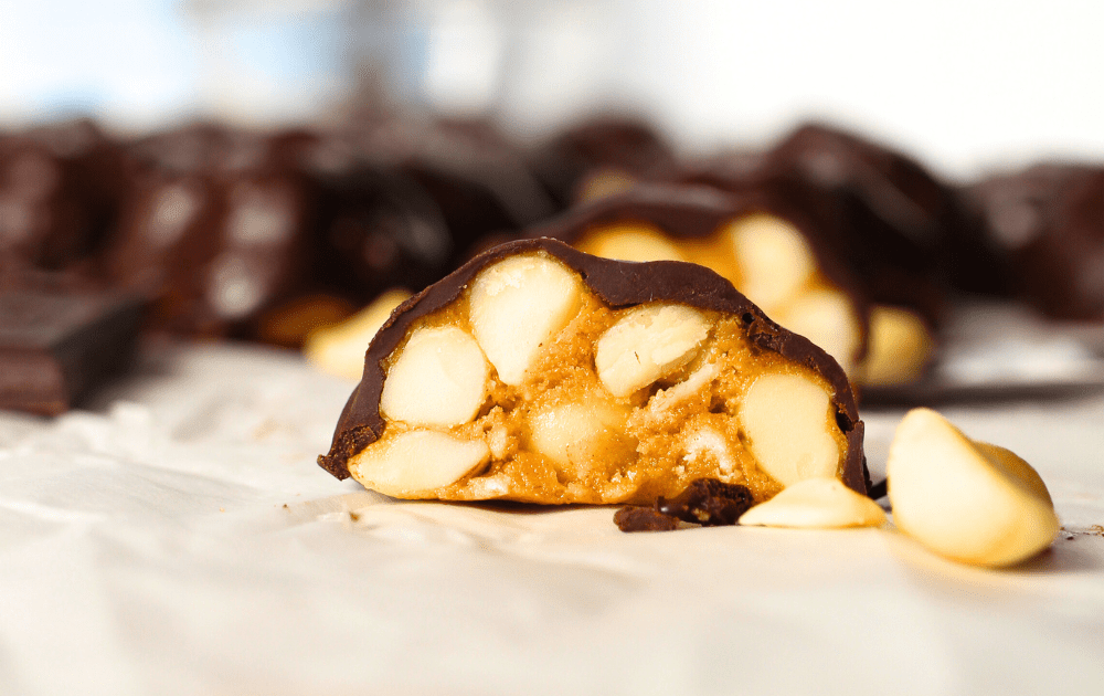 front view of homemade chocolate macadamia clusters sliced in half