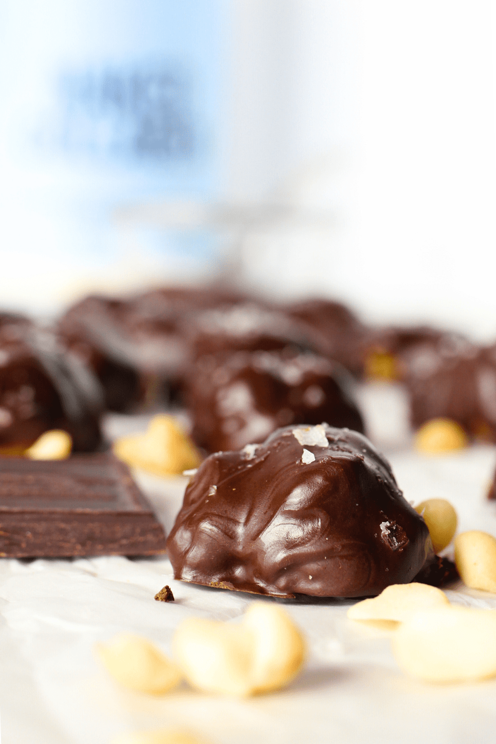 front view of a homemade chocolate macadamia cluster with sea salt sprinkled on top