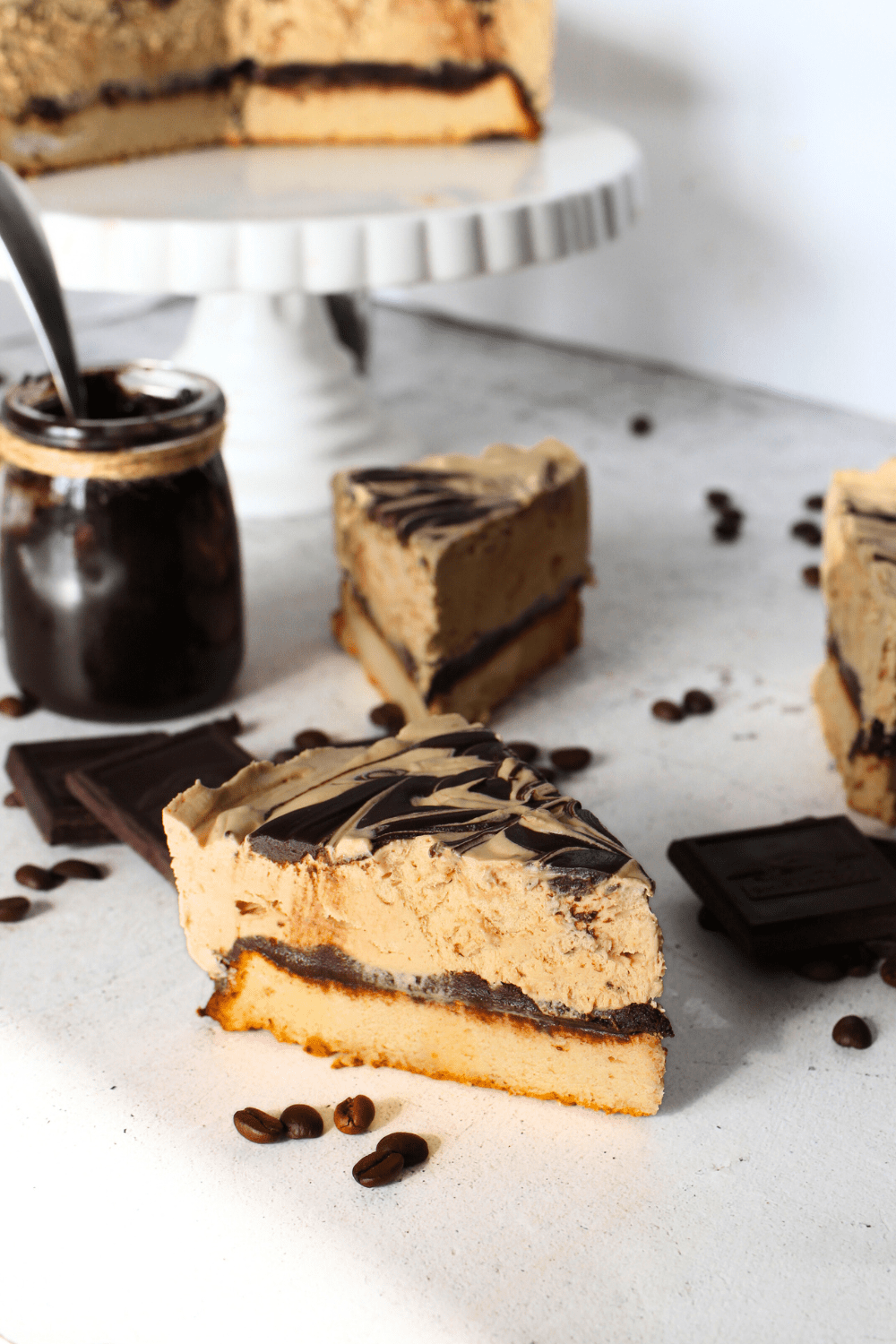 a slice of sugar-free homemade ice cream cake with a keto chiffon cake layered with sugar-free homemade fudge sauce and a no-churn keto coffee ice cream