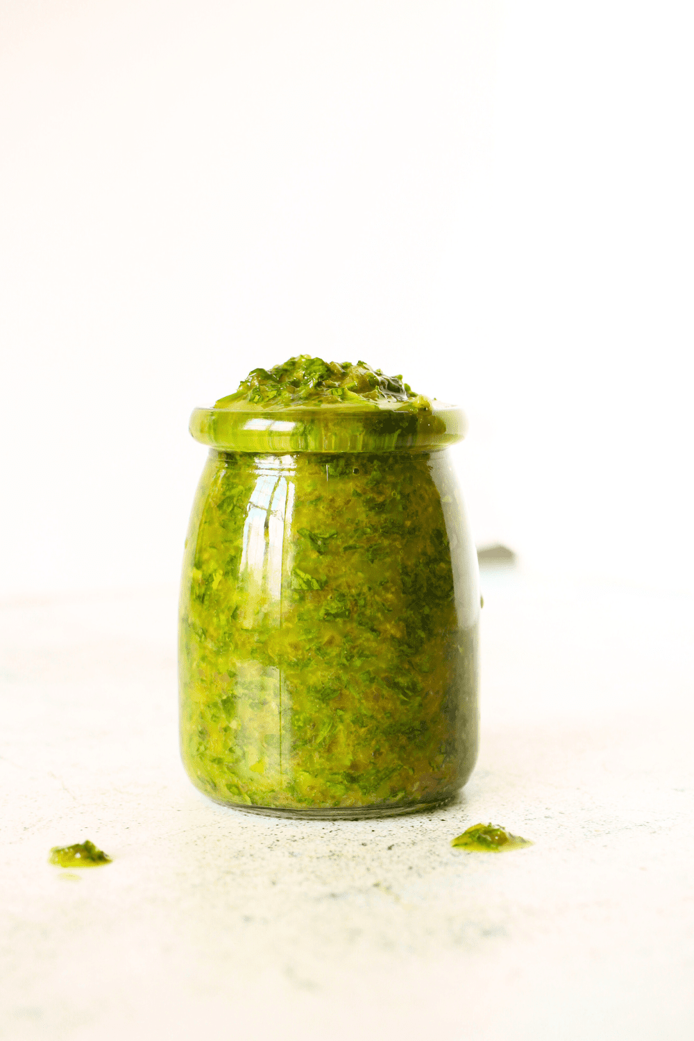 a front view of a glass jar with keto chimichurri sauce that is cilantro-free