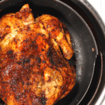 cooked rotisserie chicken in the air fryer basket