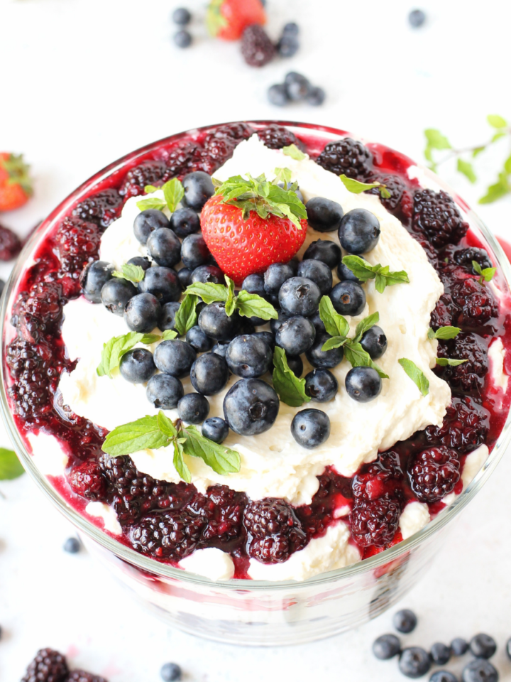 keto trifle with layers of almond sponge cake and mixed summer berries