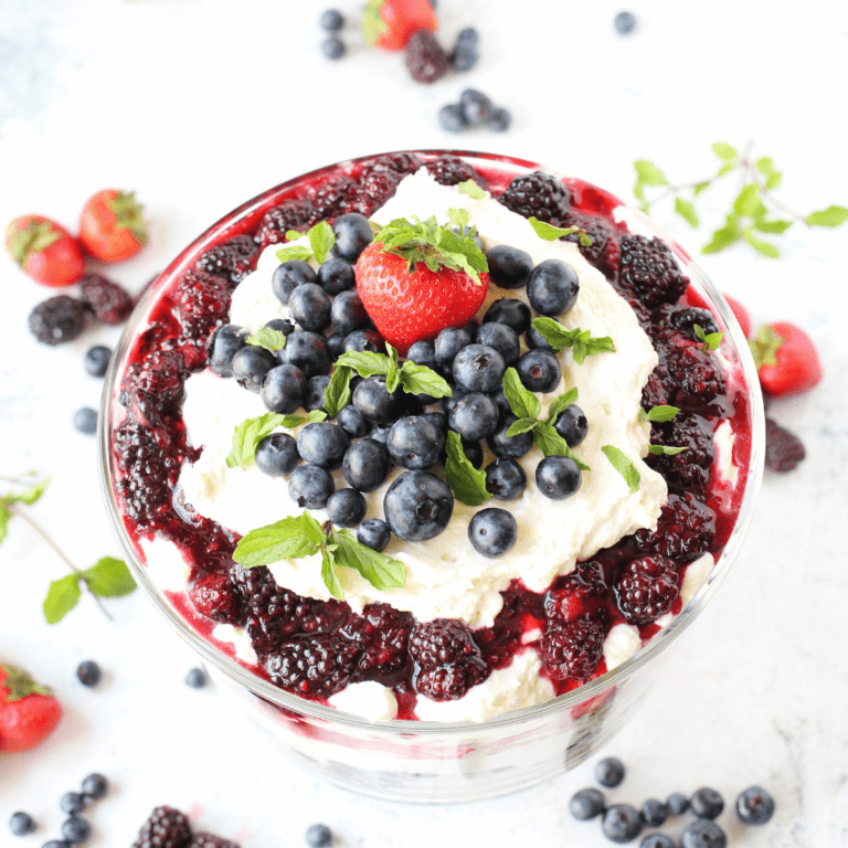 keto trifle with layers of almond sponge cake and mixed summer berries