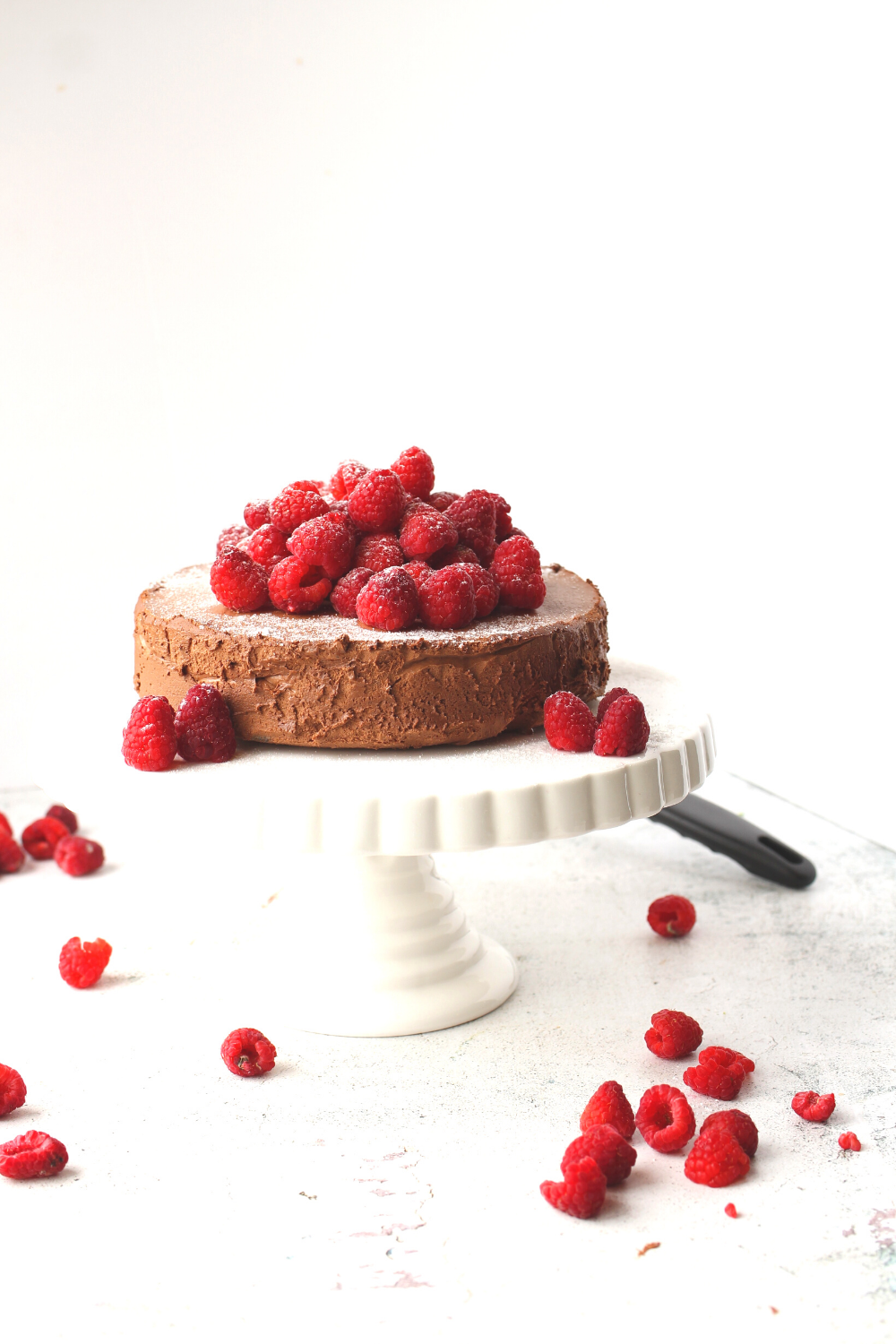 chocolate flourless cake that is keto and sugar-free on a serving platter