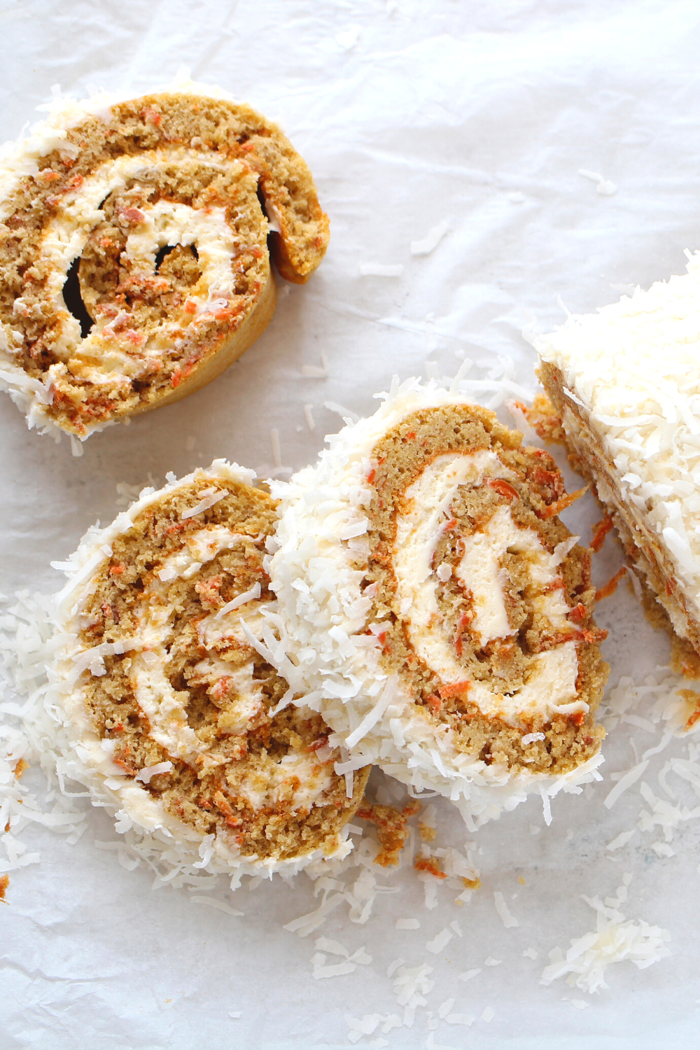 slices of sugar-free, gluten-free and keto Swiss roll cake with  cream cheese frosting