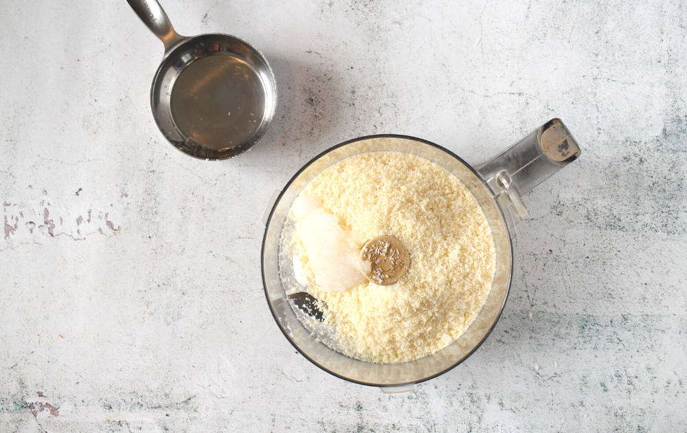 Instructions for making Homemade coconut butter - add the shredded unsweetened coconut with the coconut oil in the bowl of a food processor