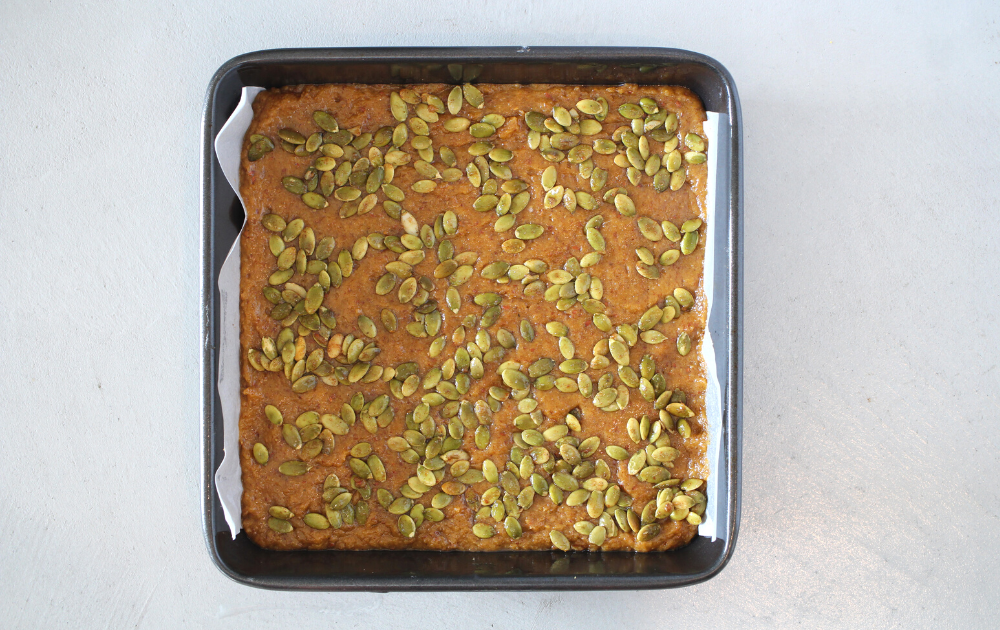 Instructions - Spread the keto pumpkin blondies into a parchment lined baking sheet and sprinkle with pumpkin seeds if desired