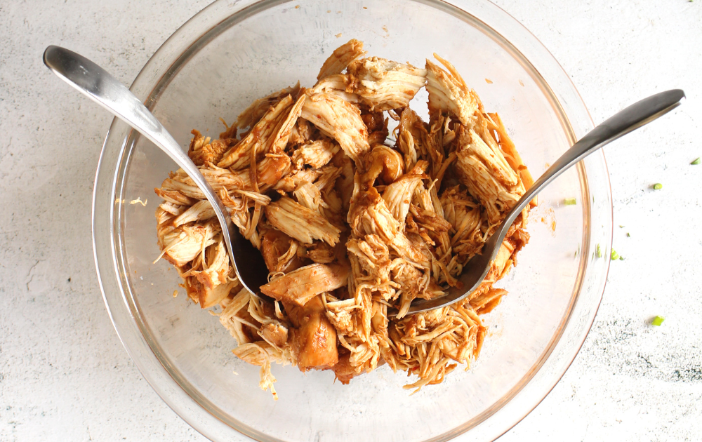 Step 2 - Once the chicken is down, remove it from the slow cooker and place it in a bowl.  Using 2 forks, shred the chicken