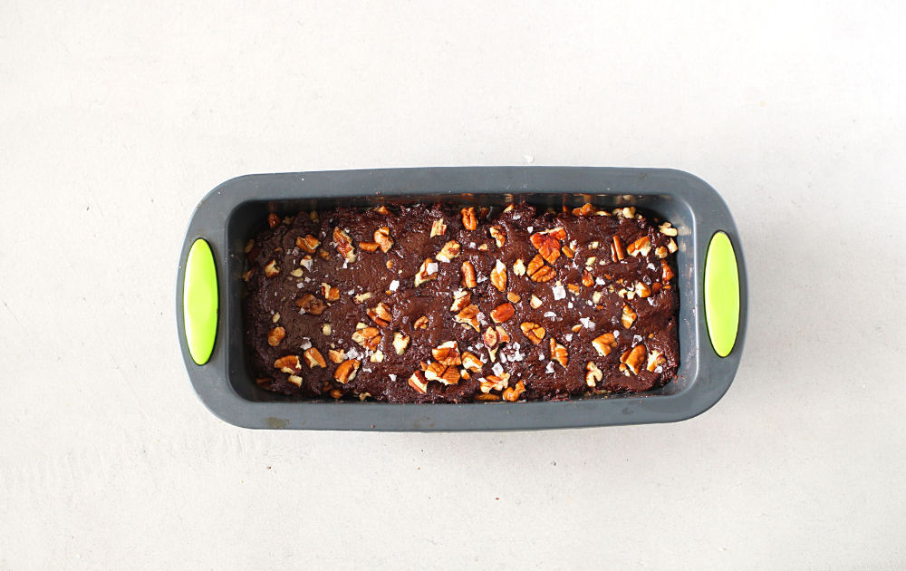 Instructions - Step 4 - Spread the remaining chocolate over the caramel pecan layer and sprinkle with additional chopped pecans and sea salt
