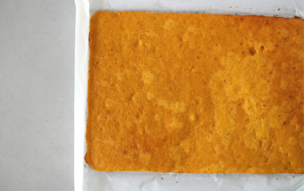 Instructions - Using the parchment paper overhang, start rolling the parchment paper and eventually the pumpkin cake into a tight roll. Allow the cake to fully cool at room temperature