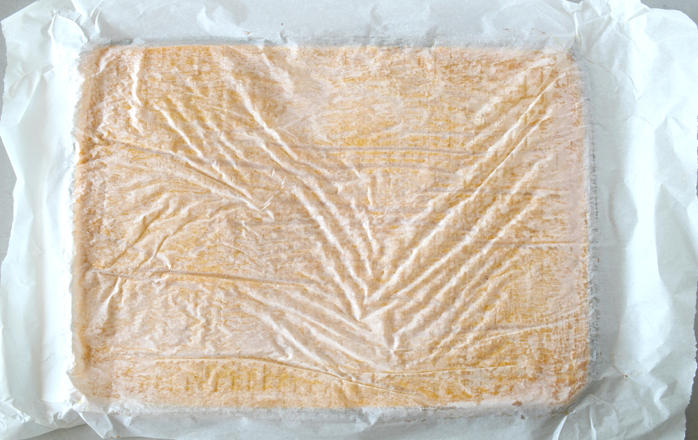 Instructions - Line a cooling rack with parchment paper and flip the roll cake onto the new piece of parchment paper. Carefully peel the old parchment paper off the cake