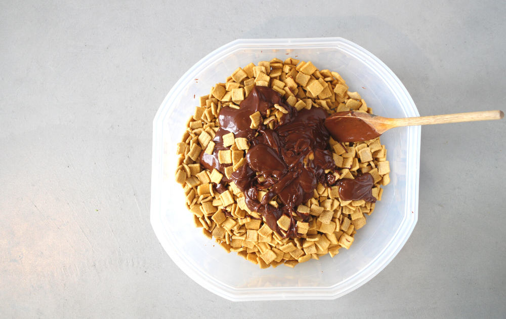 Pour the chocolate mixture over the cereal and stir thoroughly to ensure that all the cereal has been covered by the chocolate.
