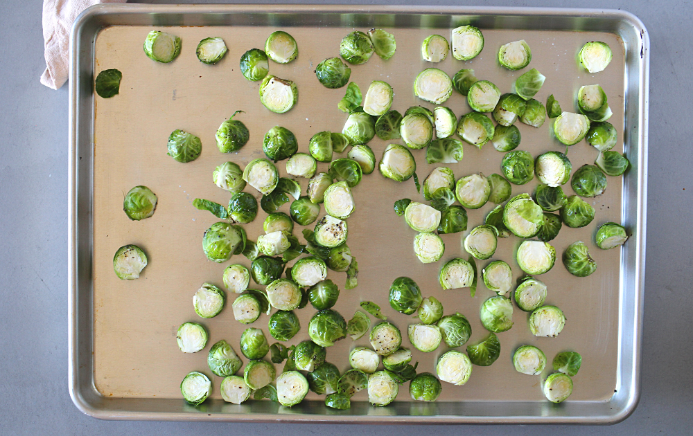 Place the Brussels sprouts on a preheated baking sheet and bake at 450 degrees for 18 minutes.  While the sprouts are roasting, place the broccoli in a large microwaveable bowl and microwave on high for 2 minutes.