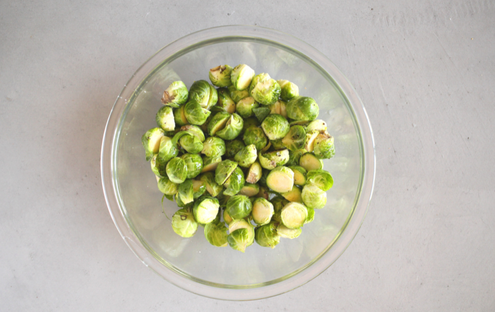 Slice the Brussels sprouts in half and toss with salt and pepper. 