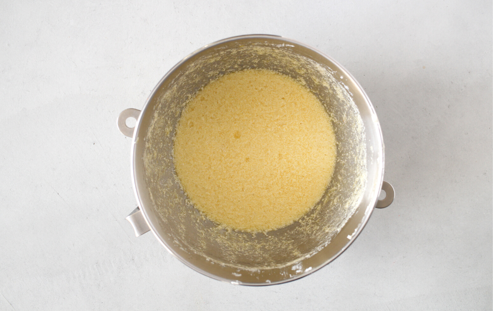 Prepare Bundt pan by greasing it very well. In the bowl of a stand mixer or a large mixing bowl, cream the butter with the white sweetener until light and fluffy. Add in the eggs, one at a time until all the eggs have been fully incorporated.