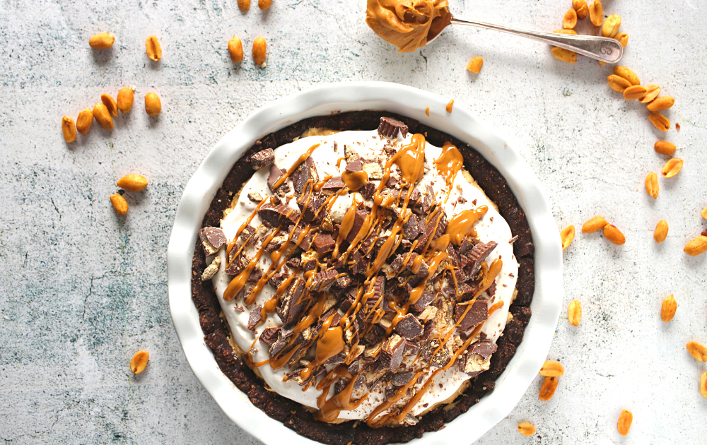 spread the peanut butter filling and top with whipped cream. Add chopped peanut butter cups and dizzle with melted peanut butter