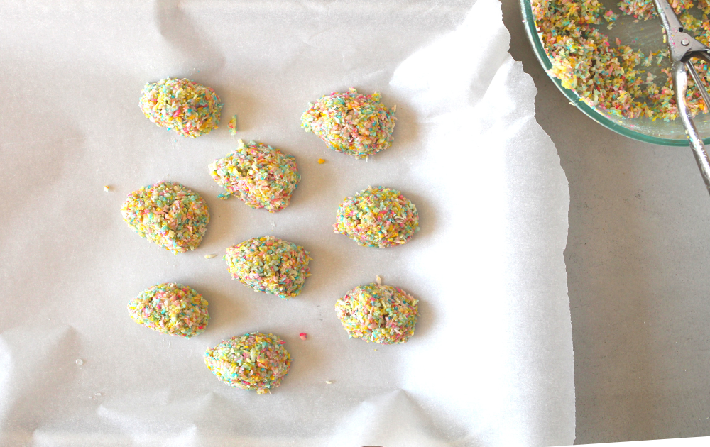 Scoop out a packed, level tablespoon of the coconut mixture. You should end up with 16 total. Shape the coconut into little round egg shapes and gently place on a plate. Place the coconut eggs in the freezer for about 10 minutes to harden.