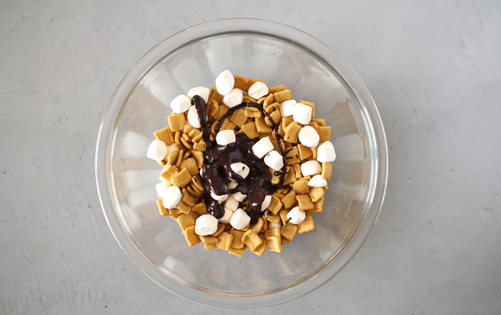 Pour the chocolate over the cereal and marshmallows until all the ingredients are well coated.
